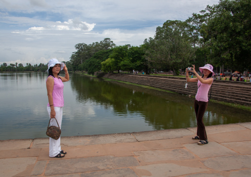 Tourists taking pictures in front of the Angkor wat pond, Siem Reap Province, Angkor, Cambodia