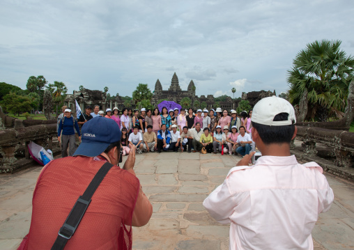 Tourists taking pictures in front of the Angkor wat, Siem Reap Province, Angkor, Cambodia