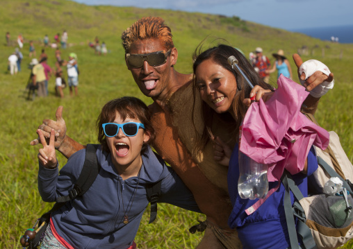 Japanese Tourists Pausing With A Rapanui Man After His Banana  Haka Pei Competition, Easter Island, Chile