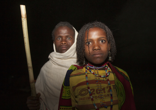 Night Shot Of A Karrayyu Tribe Man And Girl With Stranded Hair During Gadaaa Ceremony, Metahara, Ethiopia