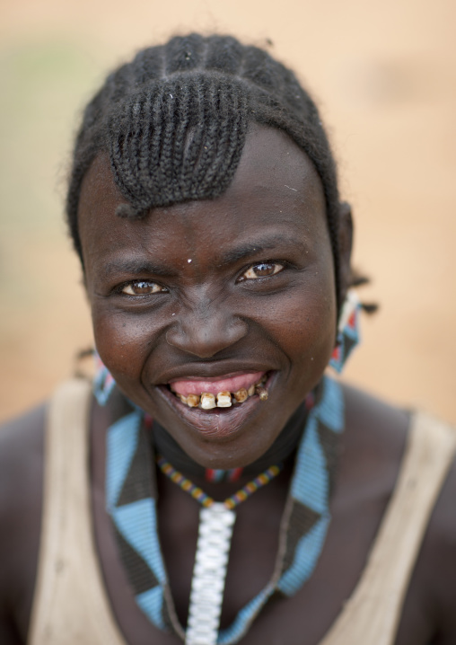 Tsemay tribe woman smiling with damaged teeth at key afer market, Omo valley, Ethiopia