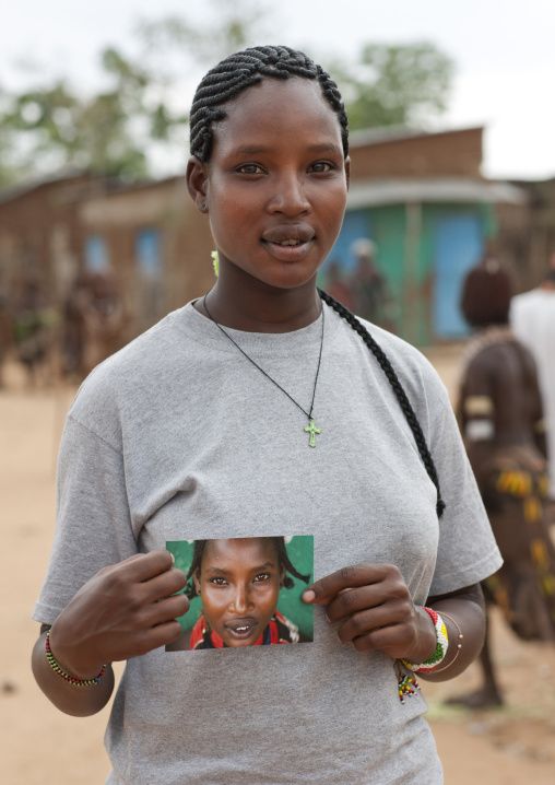 Ex Tribal Young Hamer Woman Converted To Christianity Civilization   Posing With Photo Of Herself Omo Valley Ethiopia
