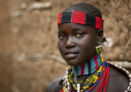 Portrait Of Hamer Beautiful Teenage Girl Posing In Front Of Clay House  Omo Valley Ethiopia