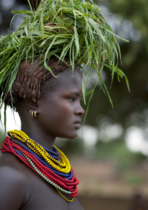 Dassanech Young Woman Carrying Load Of Green Grass On Head And Beaded Necklaces Omo Valley Ethiopia