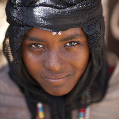 Close Up Of A Young And Smiling Karrayyu Tribe Girl With Black Headscarf During Gadaaa Ceremony, Metahara, Ethiopia