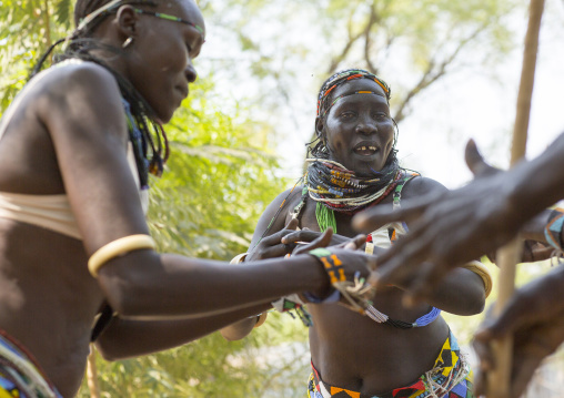 Woman From Anuak Tribe In Traditional Clothing Dancing, Gambela, Ethiopia