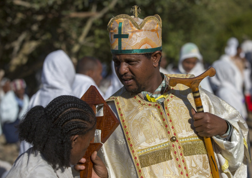 Ethiopian Orthodox Priest Blessing The Pilgrims With A Cross During The Timkat Epiphany Festival, Lalibela, Ethiopia