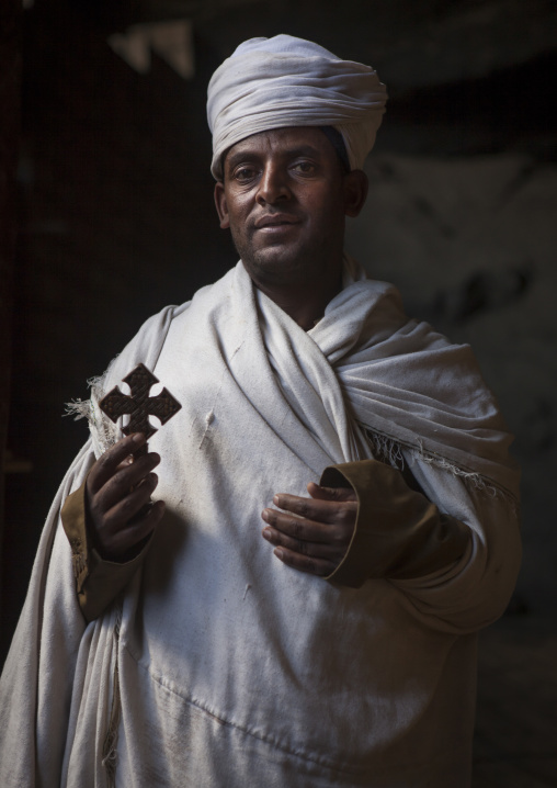 Priest Holding A Cross Inside Yemrehana Krestos Rock Church, Lalibela, Ethiopia