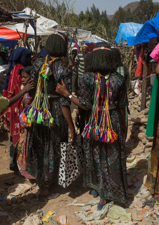 Rear view of oromo teenage girls with pompoms to show they are singles, Oromo, Sambate, Ethiopia