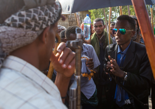 Oromo groom with an umbrella during his wedding celebration, Oromo, Sambate, Ethiopia