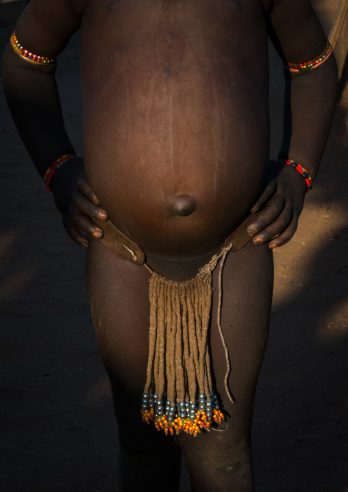 Hamer tribe little girl with a beaded loincloth, Omo valley, Turmi, Ethiopia