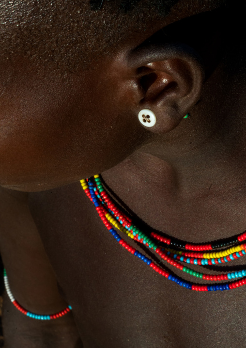 Hamer tribe girl with a button used as earring, Omo valley, Turmi, Ethiopia