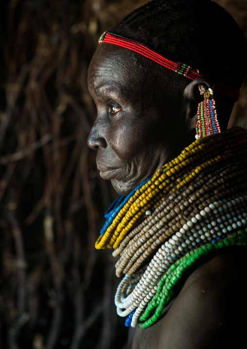 Nyangatom tribe woman with piles of beads, Omo valley, Kangate, Ethiopia