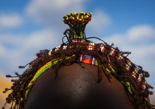Nyangatom tribe teenage girl with an headgear that indicates she is single, Omo valley, Kangate, Ethiopia