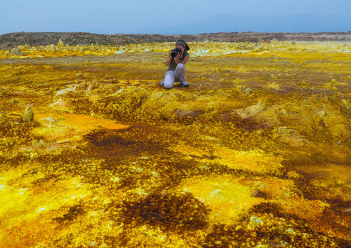 Tourist taking picture of the colorful volcanic landscape of dallol in the danakil depression, Afar region, Dallol, Ethiopia