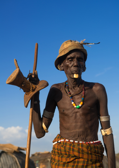 Dassanech old man with ivory jewels during dimi ceremony to celebrate circumcision of the teenagers, Omo valley, Omorate, Ethiopia