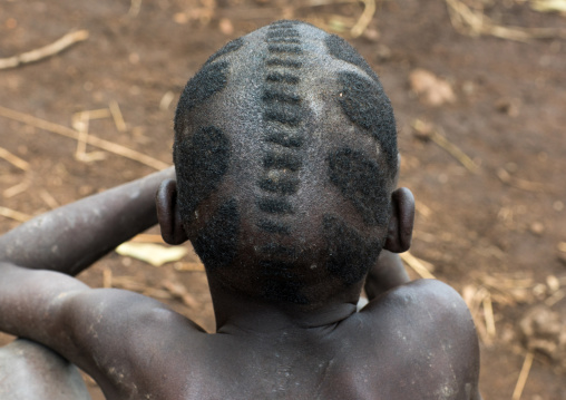 Mursi tribe kid with traditional hairstyle, Omo valley, Mago park, Ethiopia