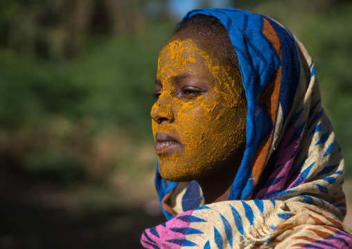 Afar tribe teenage girl with qasil on her face, Afar region, Afambo, Ethiopia