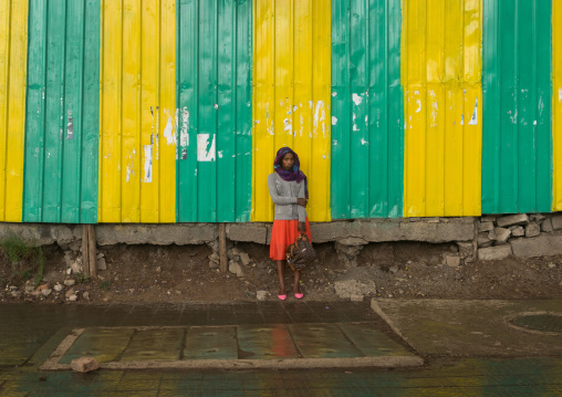 Woman looking for shelter under the rain, Addis abeba region, Addis ababa, Ethiopia