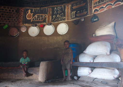 Ethiopia, Kembata, Alaba Kuito, ethiopian children inside a traditional house with decorated and painted walls