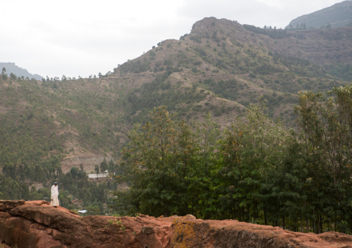 Lonely ethiopian man walking along a hill, Amhara region, Lalibela, Ethiopia