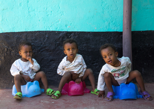 Ethiopian triplets on the potty, Harari Region, Harar, Ethiopia