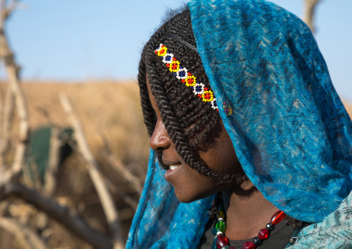 Side view of an Afar tribe woman with braided hair and a beaded headdand, Afar region, Chifra, Ethiopia