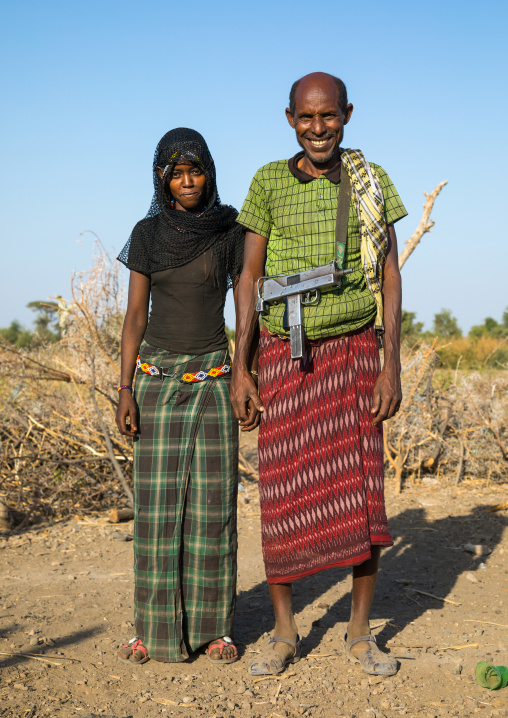 Afar tribe husband with his young second wife, Afar region, Chifra, Ethiopia