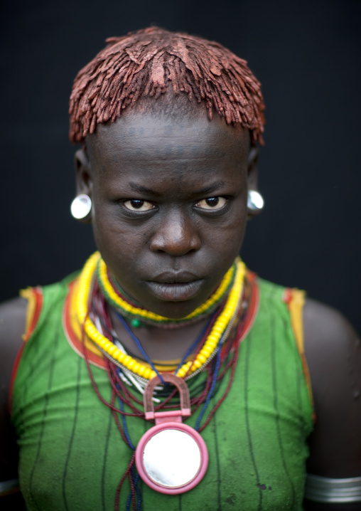 Menit young womanwearing ear labrets, Tum market, Omo valley, Ethiopia