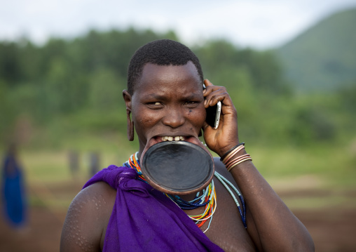 Suri Woman With Lip Plate And Mobile Phone, Turgit Village, Omo Valley, Ethiopia
