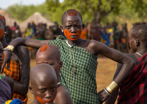 Teenage girls with makeup on the face during the fat men ceremony in Bodi tribe, Omo valley, Hana Mursi, Ethiopia
