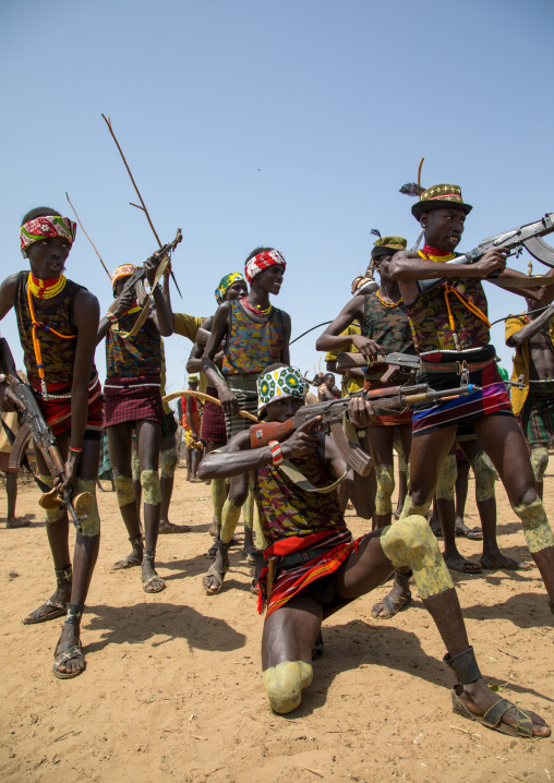 Men shooting with kalashnikovs during the proud ox ceremony in the Dassanech tribe, Turkana County, Omorate, Ethiopia