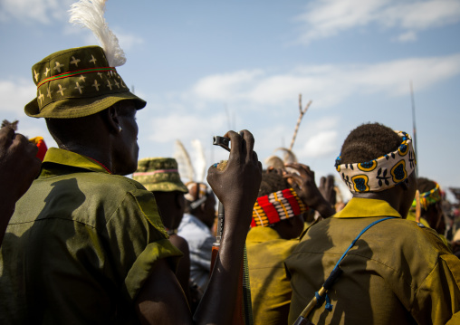 Tribe warriors during the proud ox ceremony in the Dassanech tribe waiting to share the cow meat, Turkana County, Omorate, Ethiopia