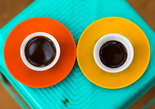 Two cups of coffee seen from above on a green plastic table, Omo valley, Key Afer, Ethiopia