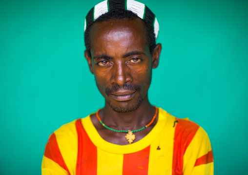 Portrait of a Hamer tribe man wearing a barcelona football shirt, Omo valley, Dimeka, Ethiopia
