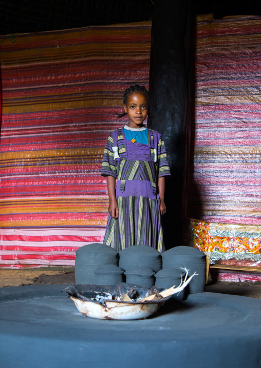 Gurage girl inside her traditional house in front of the fireplace, Gurage Zone, Butajira, Ethiopia