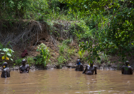 Bodi tribe fat men taking a bath before the Kael ceremony, Omo valley, Hana Mursi, Ethiopia