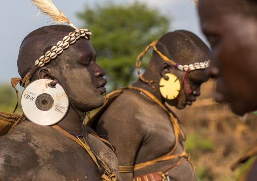 Bodi tribe fat man with cd as earrings during Kael ceremony, Omo valley, Hana Mursi, Ethiopia