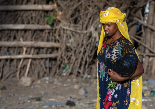 Oromo woman in a market with a yellow scarf, Amhara region, Senbete, Ethiopia