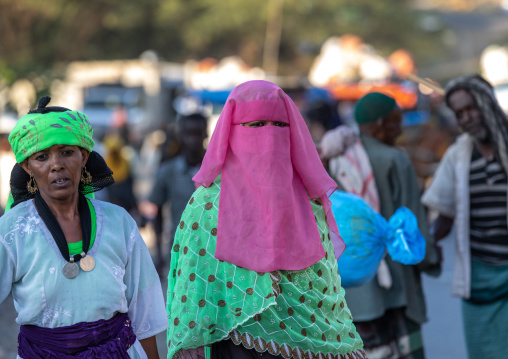 Oromo woman wearing a pink burqa in the market, Amhara region, Senbete, Ethiopia