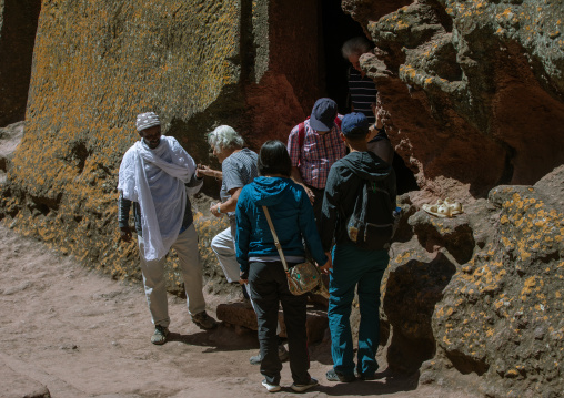 Tourists visiting a monolithic rock-cut church, Amhara Region, Lalibela, Ethiopia