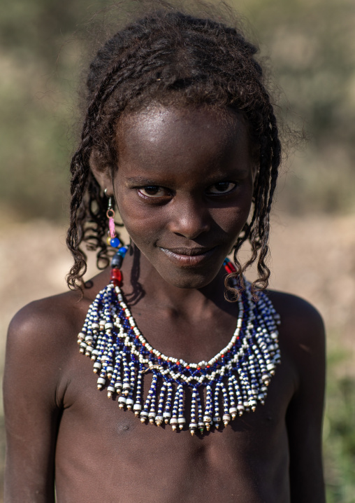 Portrait of an afar tribe girl with a beaded necklace, Afar region, Mile, Ethiopia