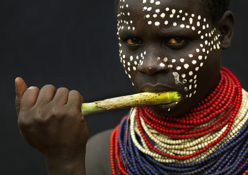 Karo Woman With Siwak Stick In Mouth Painted Face And Necklaces Ethiopia