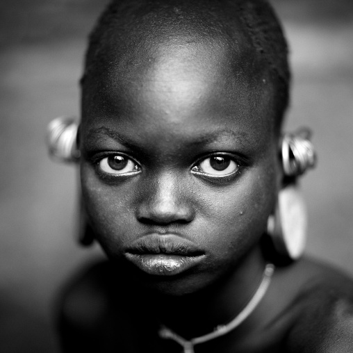 Suri tribe girl with enlarged earlobes, Kibish, Omo valley, Ethiopia