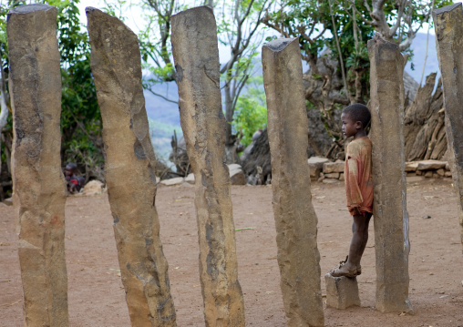 Kid Leaning On A Konso Stone Pillar In The Ceremony Square, Omo Valley, Ethiopia