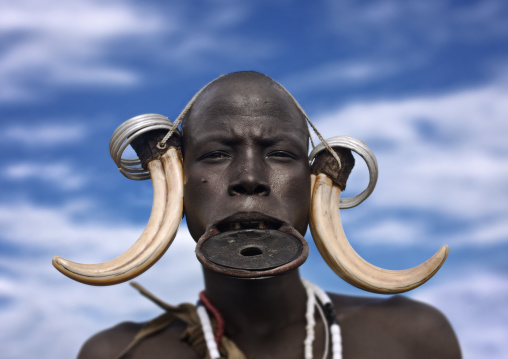 Portrait Of A Mursi Tribe Woman With Lip Plate And Enlarged Ears In Mago National Park, Omo Valley, Ethiopia