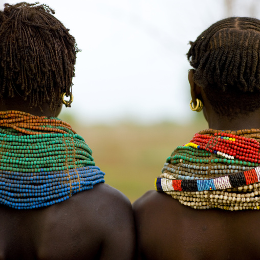 Rear View Of Nyangatom Tribe Women With Huge And Colourful Necklaces, Omo Valley, Kangate, Ethiopia