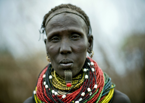 Portrait Of A Senior Nyangatom Tribe Woman Wearing Some Big Beaded Necklaces, Omo Valley, Ethiopia