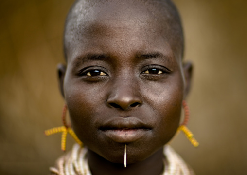 Portrait Of A Karo Tribe Woman With Yellow Earrings And Pierced Chin, Korcho Village, Ethiopia