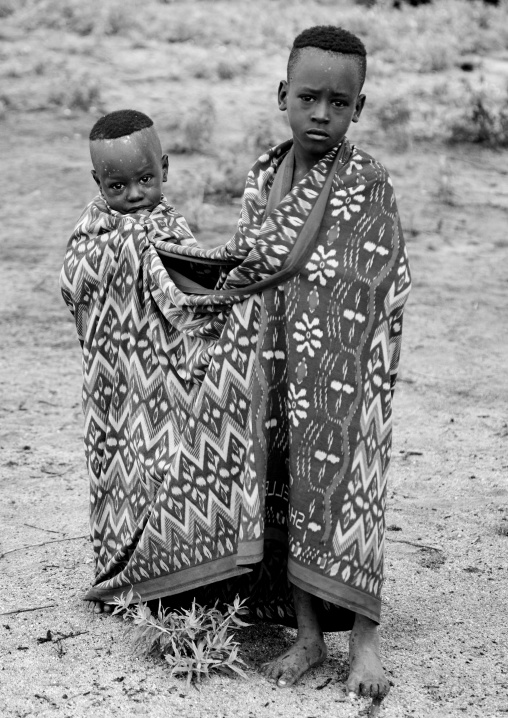 Black And White Portrait Of Karo Tribe Kids Wrapped Up In A Shared Blanket, Korcho Village, Omo Valley, Ethiopia